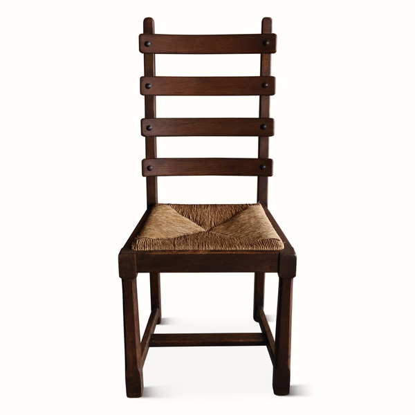 Oak ladderback chair with woven beige seat cushion and dark wood frame.