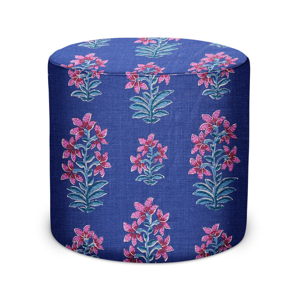 Indoor fabric pouf in dark blue with pink floral pattern, rounded cylinder
