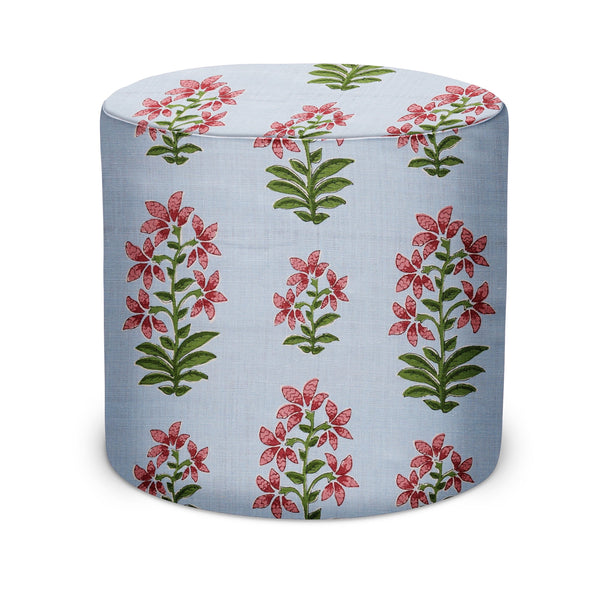 Round upholstered indoor pouf, light blue fabric with pink and green floral pattern