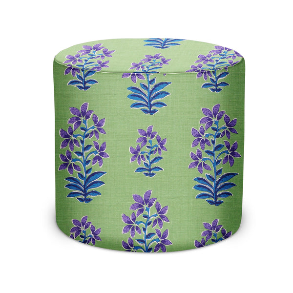 Indoor pouf ottoman with green fabric and purple/blue floral pattern, round top