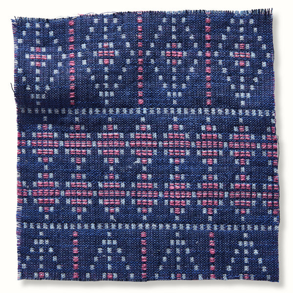 Blue outdoor pillow cover with pink woven pattern and fringed edges