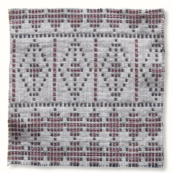 Outdoor souk pillow cover with pink, gray, and white geometric woven pattern