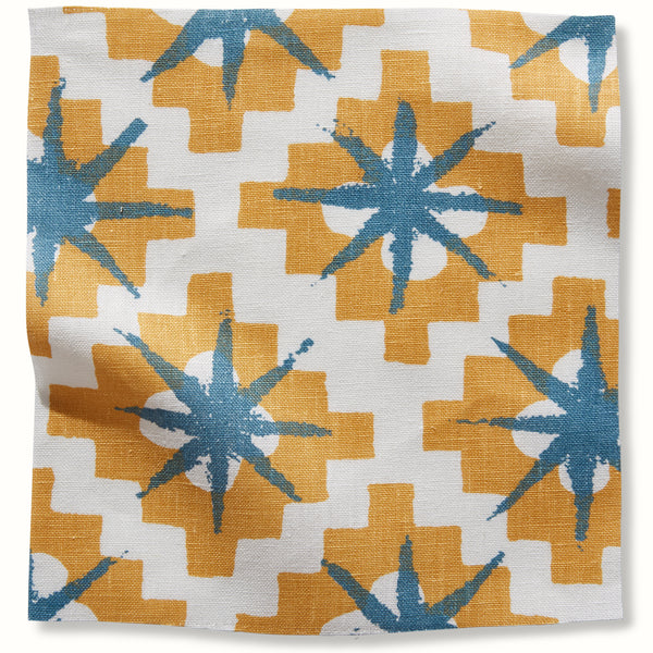 Starburst patterned pillow cover in white, yellow, and blue with star flower motifs