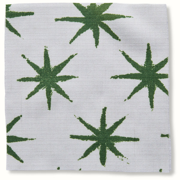Peter Dunham outdoor pillow cover with green starburst pattern on light base