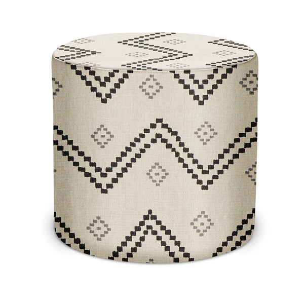 Indoor pouf with round top and geometric aztec pattern in black on light beige fabric