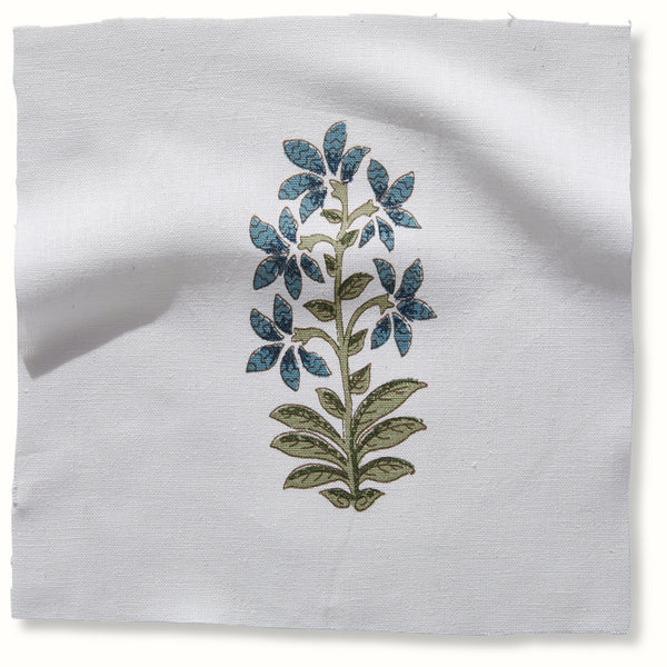 Indigo floral pillow with blue flower stem on light fabric