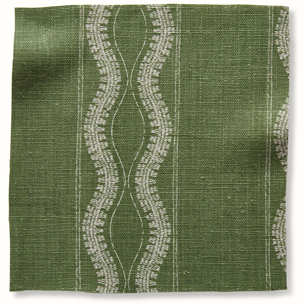 Green decorative pillow with vertical white carved pattern and grid lines