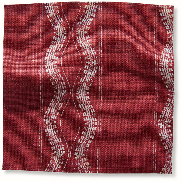 Red Zanzibar patterned pillow fabric with white wavy vertical lines