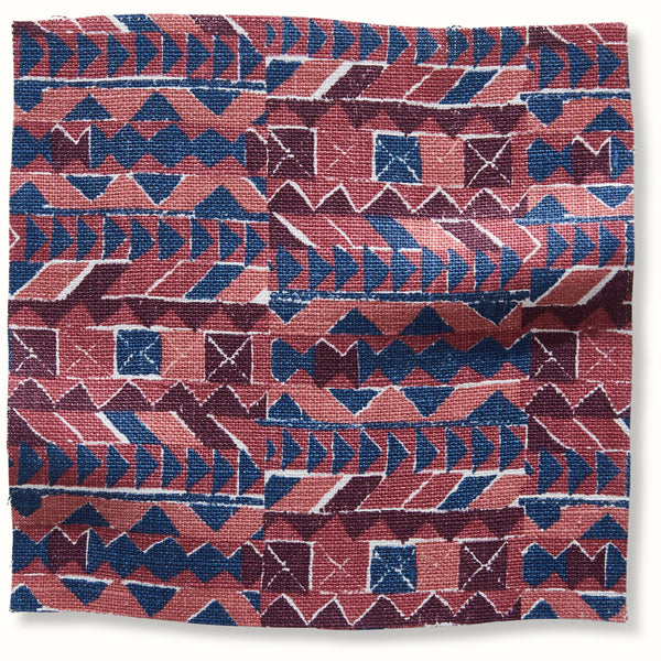 Geometric patterned pillow cover in raspberry and indigo