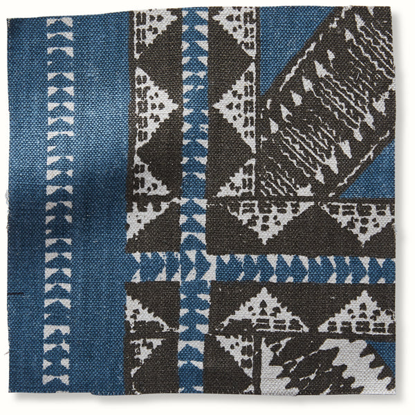 Indigo geometric Zulu-pattern pillow with woven blue, white, and dark accents