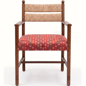 Wood armchair with rush back and red patterned upholstered seat cushion