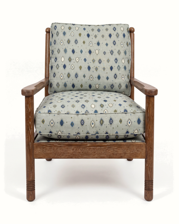 Wood lounge chair with blue and beige diamond pattern seat and back, rounded arms