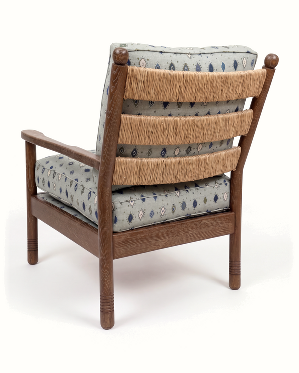 Wood lounge chair with patterned cushions and paper rush seat back