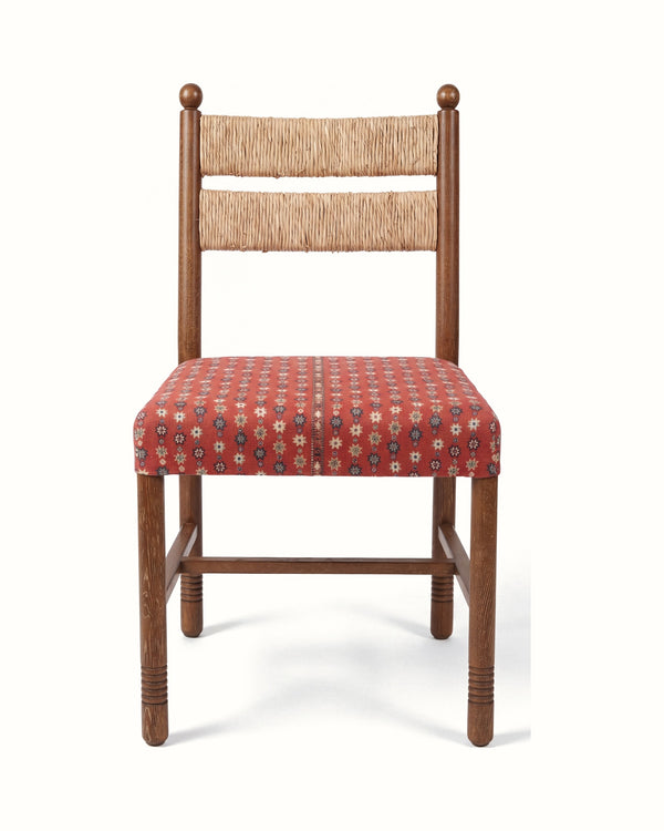 Dining chair with brown wood frame, beige upholstered back, red patterned upholstered seat.