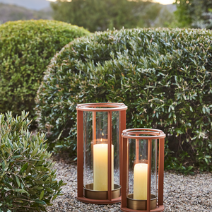 Saddle brown stitched leather lanterns with glass sides and lit candles