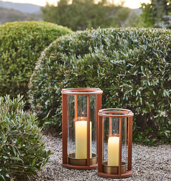 Saddle brown stitched leather lanterns with glass sides and lit candles