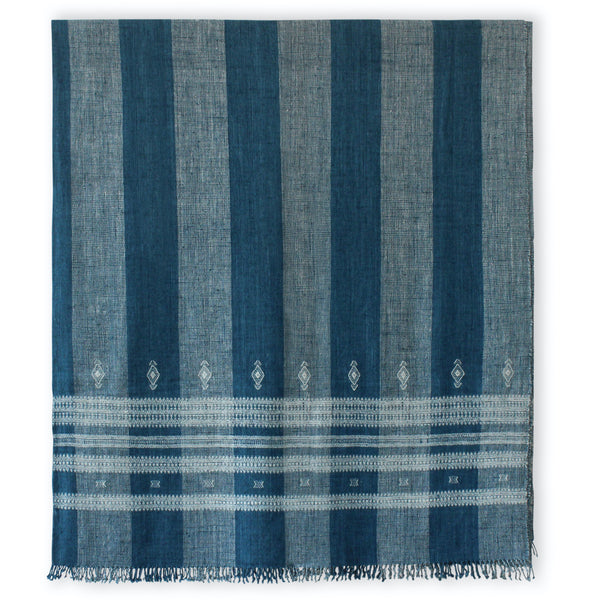 Indigo and ivory striped bedcover featuring diamond motifs and bordered woven pattern