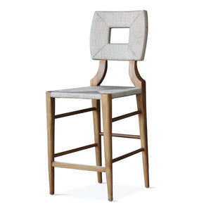 Counter stool with light sand square back cushion and upholstered seat on wood frame.