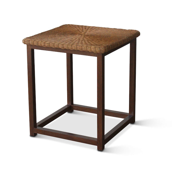 Three-quarter view of dark walnut wicker side table with woven top and open shelf.