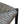 Woven rush stool seat corner with dark metal frame and round rivet cap