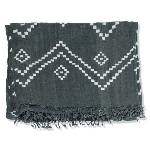 Charcoal bedcover with white zigzag diamonds and fringed trim, close-up