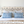 Blue and cream geometric fabric panel used as headboard upholstery with matching trim