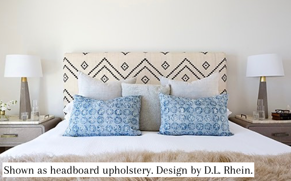 Blue and cream geometric fabric panel used as headboard upholstery with matching trim