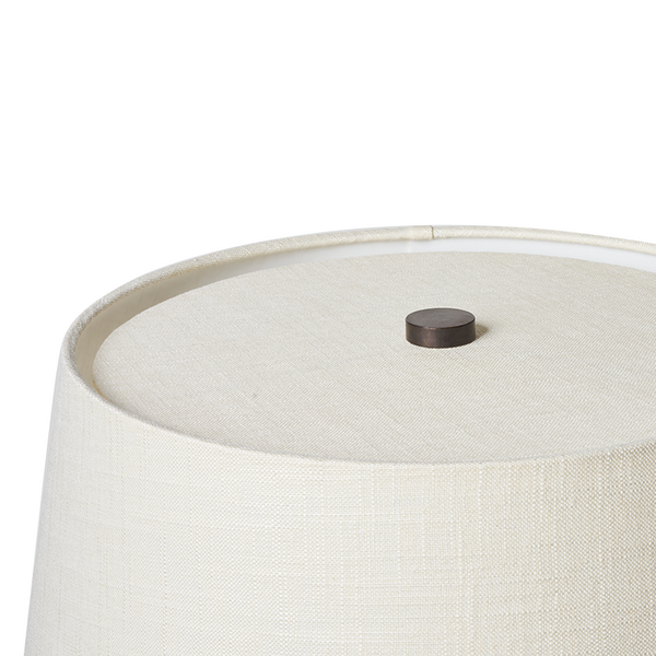 Off-white fabric lamp shade with textured weave and dark socket cap