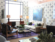 The Canyon Coffee Table is handmade in Los Angeles and designed by Peter Dunham for Hollywood at Home. The iron base, glass top, and rush shelf create an interesting visual mix of materials.