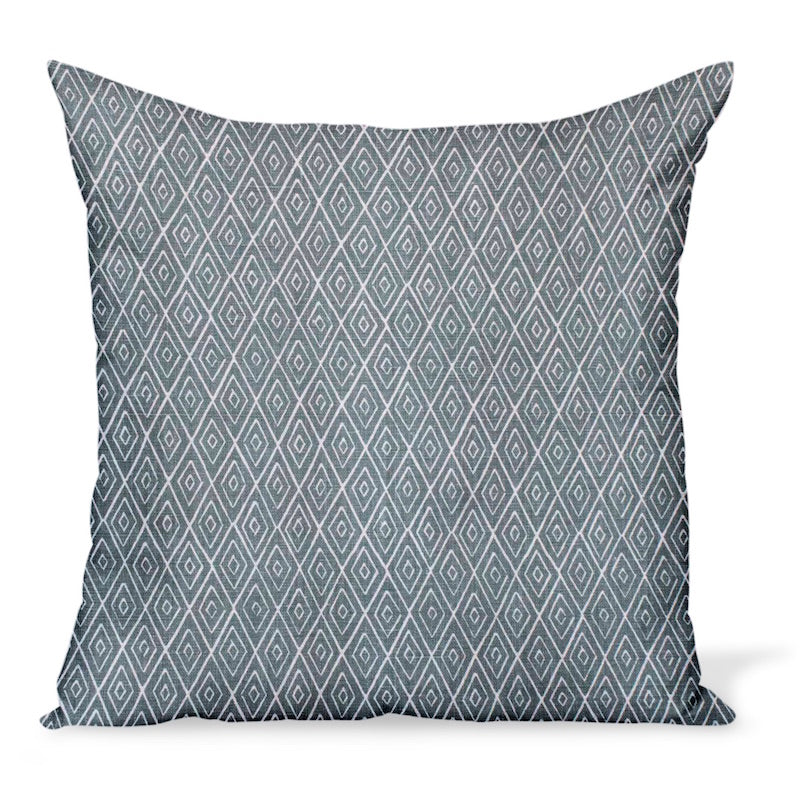 A decorative pillow or cushion made from Peter Dunham Textiles linen tribal print, Atlas in Ocean, a blue/green.