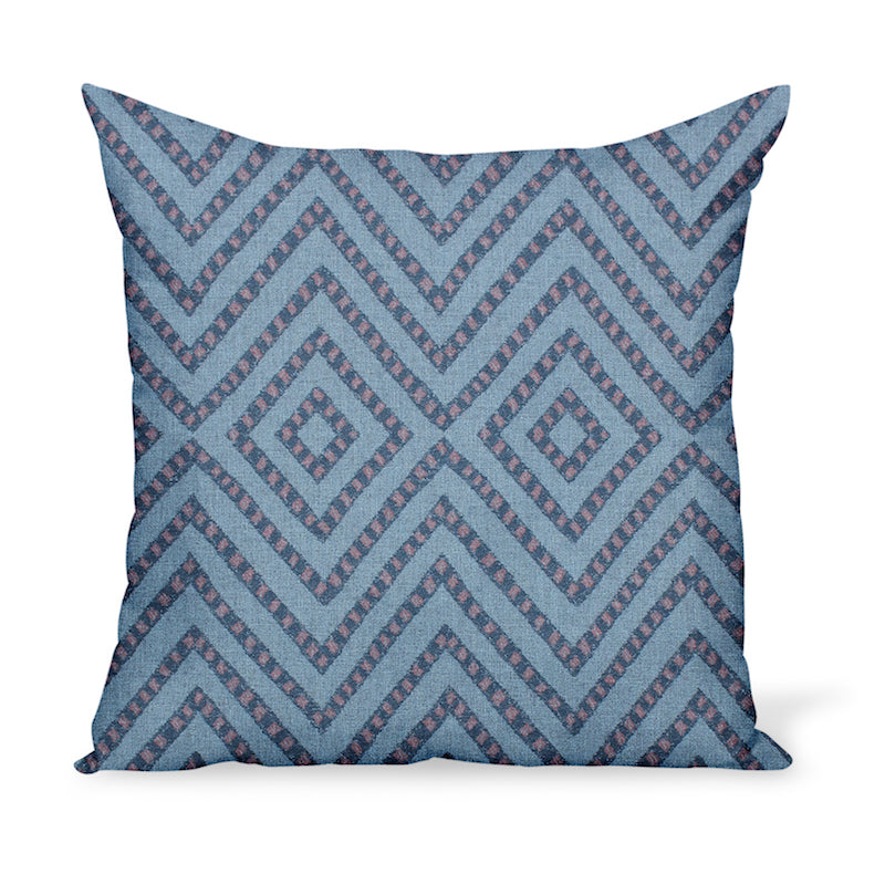 A pillow or cushion made from Peter Dunham Textiles Mansa fabric, a tribal indoor or outdoor woven with Sunbrella yarns