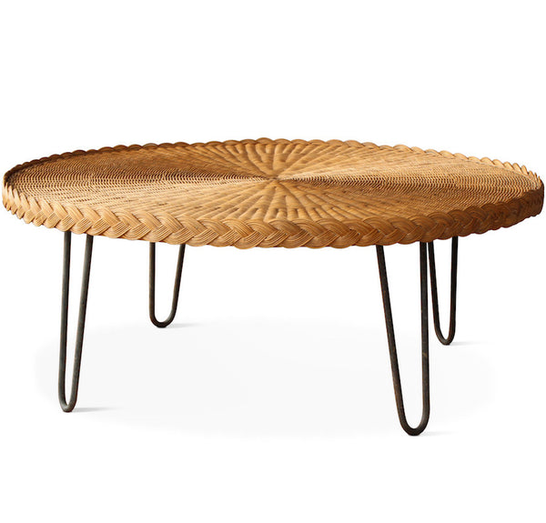 The San Remo Coffee Table features a circular wicker top with mid-century styled hairpin iron legs in a rustic patina. The table is completely handmade in Los Angeles and designed by Hollywood at Home founder Peter Dunham.
